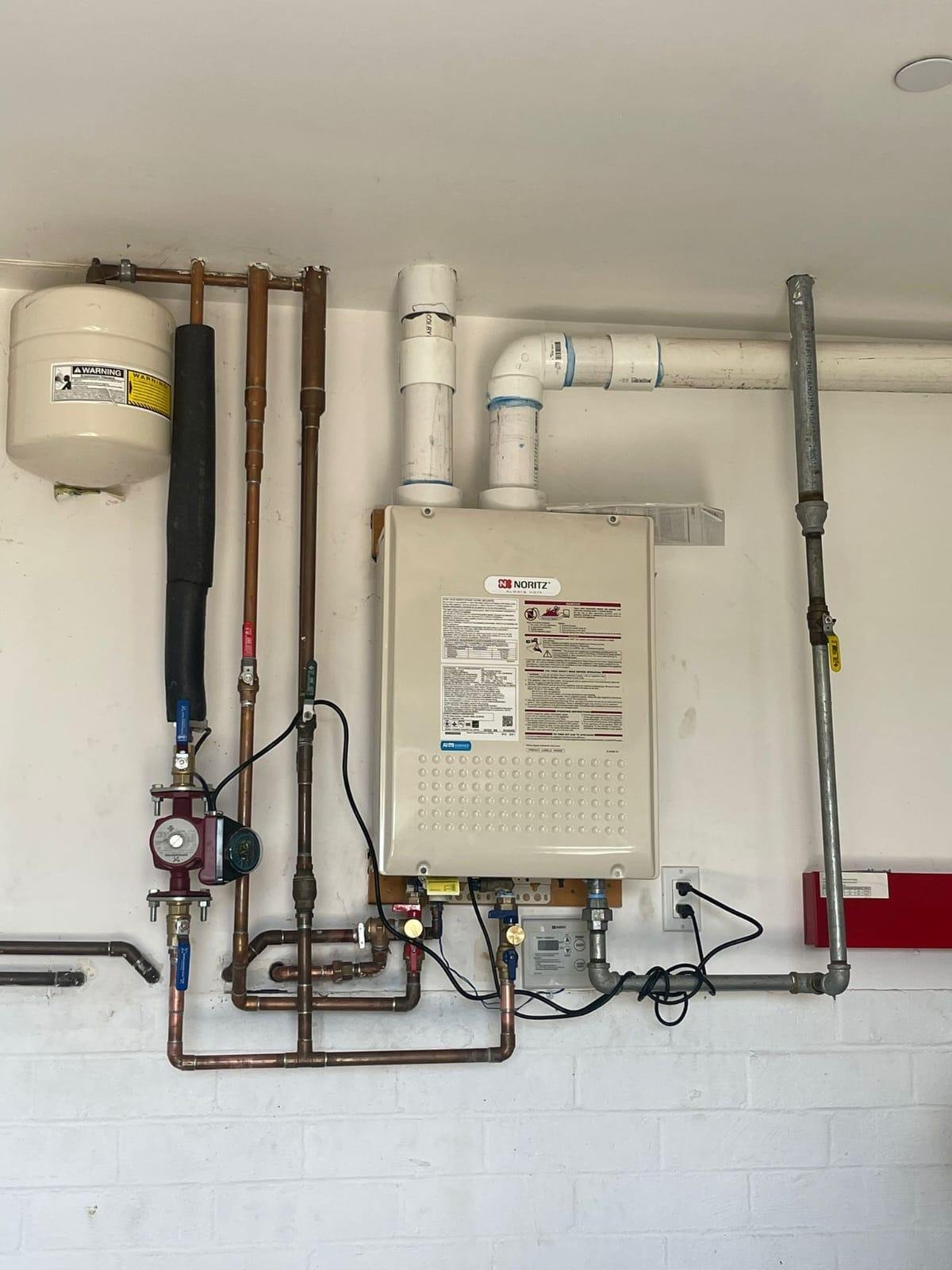 Client portfolio photograph of a wall-mounted tankless water heater