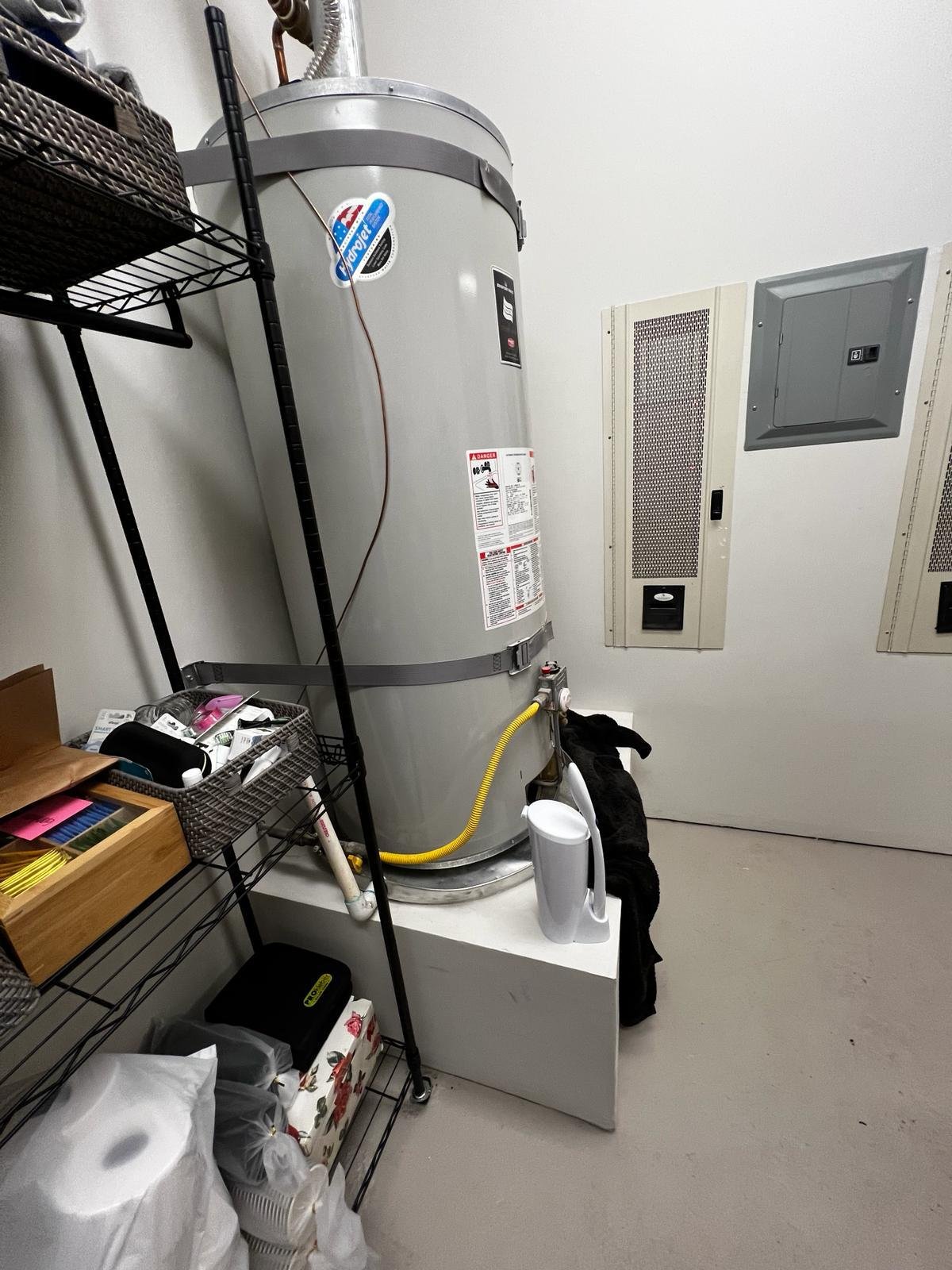 Client portfolio photograph of a traditional tank-style water heater