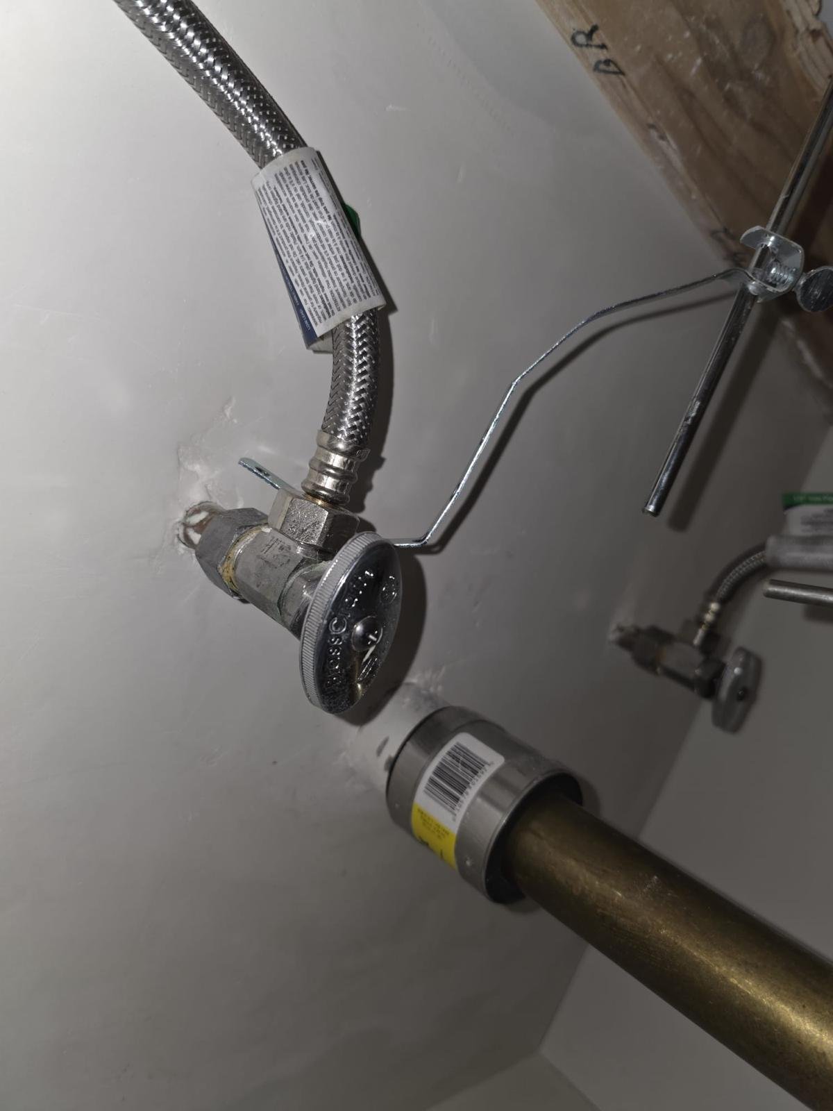 Client portfolio photograph of a plumbing connection and supply lines